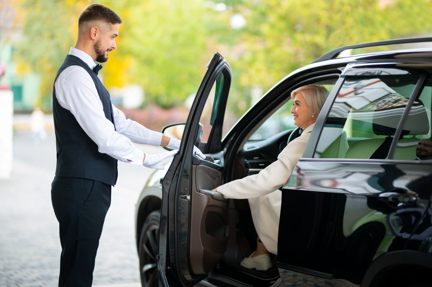 Luxury car and chauffeur at a wedding venue